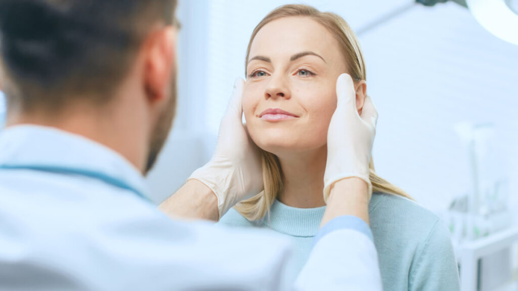 woman consulting with her cosmetic doctor if she needs another botox injection for her jawline